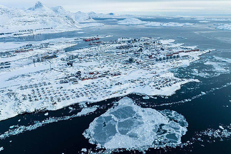 Houses covered by snow are seen on the coast of a sea inlet of Nuuk, Greenland, 7 March 2025 AP Photo