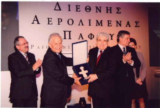 A group of men in suits receiving a certificate
Description automatically generated